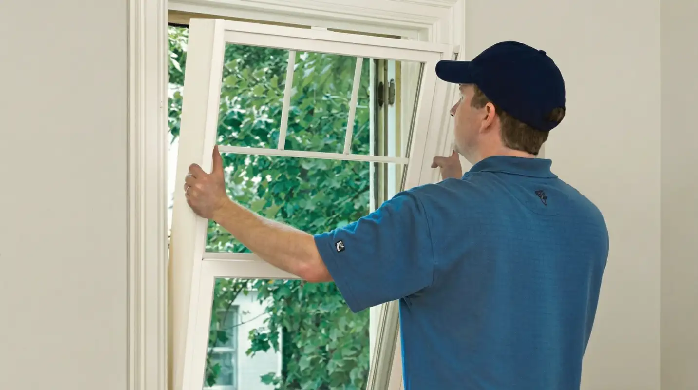 Professional contractors performing a residential window insulation and replacement service in Huntsville, AL